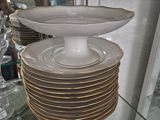 many plates stacked on top of each other on a glass shelf