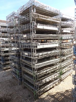 a large pile of scaffolding in a parking lot