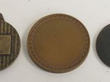 three different types of metal tags are shown on a white surface