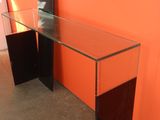 a glass table with a mirror on top of it