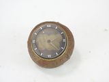 a small wooden clock with roman numerals on it