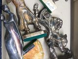 a box with silver figurines in it on a blue surface