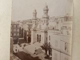an old photo of a building with a clock tower in the middle of it