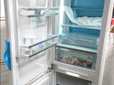 a white refrigerator with its door open on a pallet
