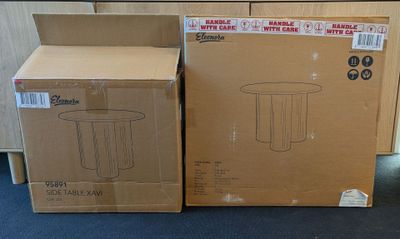 two boxes that are sitting on the floor next to each other
