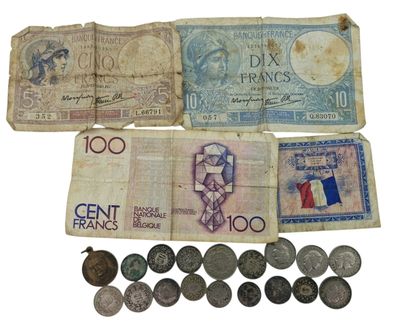 several different types of french currency are displayed on a white surface