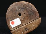 a piece of wood that has a red dot on it