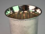 a silver cup that is sitting on a table