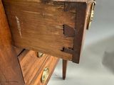 a wooden desk with a drawer on top of it