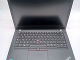 a laptop that is open on a white surface