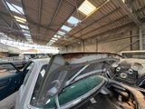 many old cars that are parked inside of a building