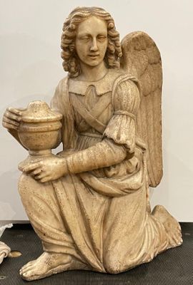 an image of a statue of an angel holding a bowl of fruit