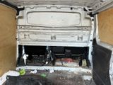 a white van that has been vandalized and is in the back of the van