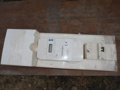 a white electronic device sitting on top of a wooden table