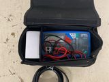 a black case with wires and a charger inside of it