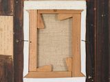 an old picture frame with a piece of paper hanging from it ' s side