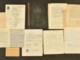 an assortment of old books and papers on a table