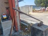 an old rusty pipe sticking out of the side of a building