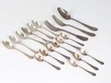 a lot of spoons and forks on the table