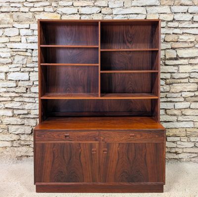 a mid century walnut bookcase with two doors and shelves