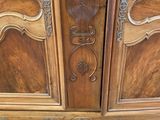 a wooden armoire with carvings on the doors