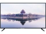 a black television sitting on top of a white table next to a lake