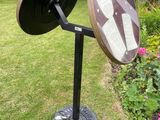 an image of a mirror on a stand in a garden