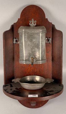 a wooden wall mounted sink with a mirror above it