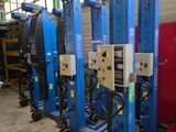 several machines are lined up in a row in a warehouse