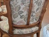 a chair with a floral upholstered back and a chair with a floral upholstered back and a chair with a floral upholstered back