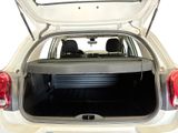 the back end of a white car with its trunk open