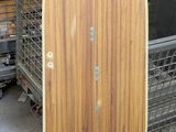 a picture of a wooden surfboard sitting on top of a metal rack