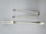 three forks and spoons sitting on top of a white surface