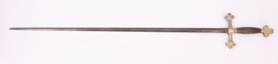 a sword that is laying on a white surface