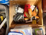 a wooden box filled with assorted items on the floor