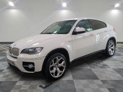 a picture of a white bmw suv on a checkered floor
