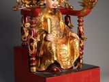an image of a statue of a man sitting on a throne