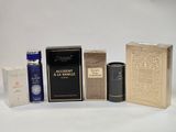several different types of perfumes and boxes on a white surface