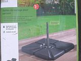 a box with a black umbrella on it on the ground
