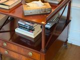 a table with books and a vase on top of it