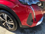 a close up of the front end of a red car