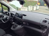 the interior of a small car with a steering wheel and dashboard