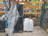 a large pile of black and white tiles on a pallet