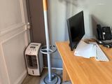 a desk with a computer and a phone on it