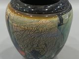 a vase that is sitting on a white surface
