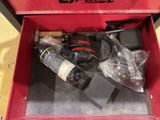 a red tool box with tools in it on the floor