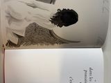 an open book with a picture of a woman on it