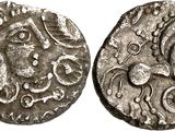 a silver coin with an image of a horse on it