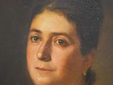 portrait of a woman in a black coat and a gold necklace