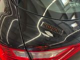 a close up of a car ' s tail light with a sticker on it